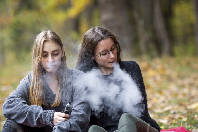 Mujeres jóvenes usan vaporizadores de nicotina